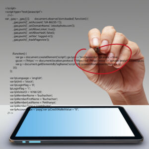A hand with pen circling html source code to be copied